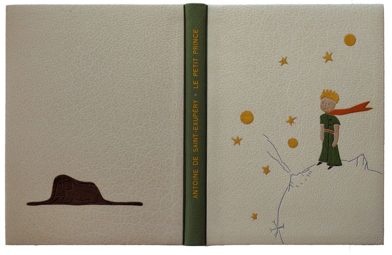A. de Saint-exupéry. Le petit prince - Montage sur onglet. Bradel à plats rapportés. Décor en mosaïque de cuirs et au fer.